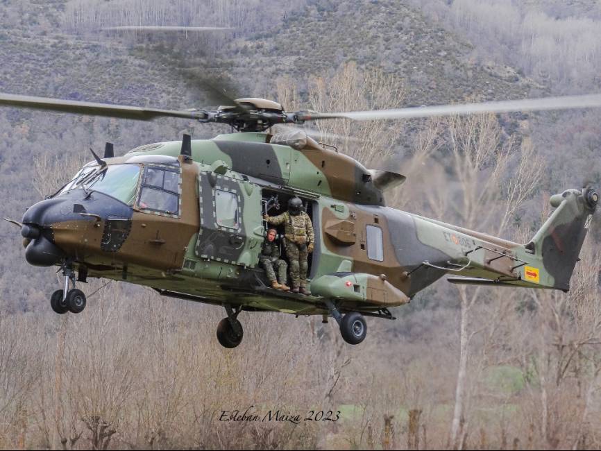Un ‘Sarrio’ (nueva denominación para los NH-90 del BHELMA III) volando en una zona montañosa.